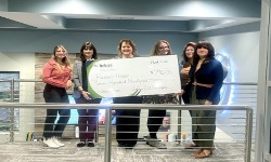 group of women holding a big check.
